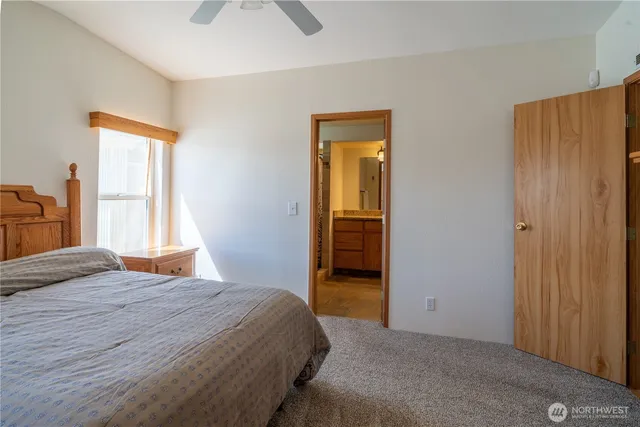 a bedroom with a dresser and a window