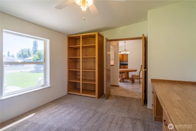 a room with a table and a ceiling fan