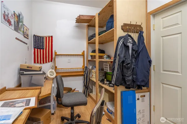 a view of a workspace with furniture and a flat screen tv