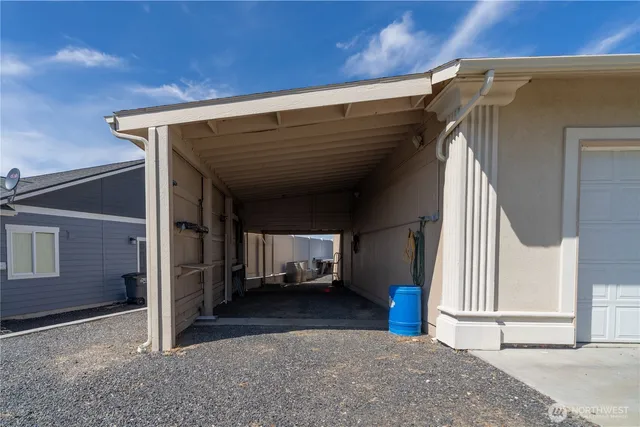an aerial view of a house with a yard and lake view