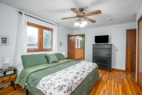 a bedroom with a bed and a flat tv screen on dresser