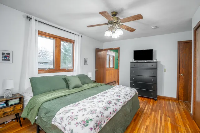 a bedroom with a bed and a flat tv screen on dresser