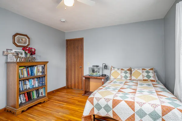 a bedroom with a bed and a book shelf