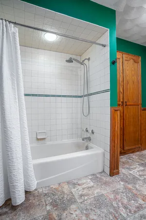 a bathroom with a bathtub and a shower