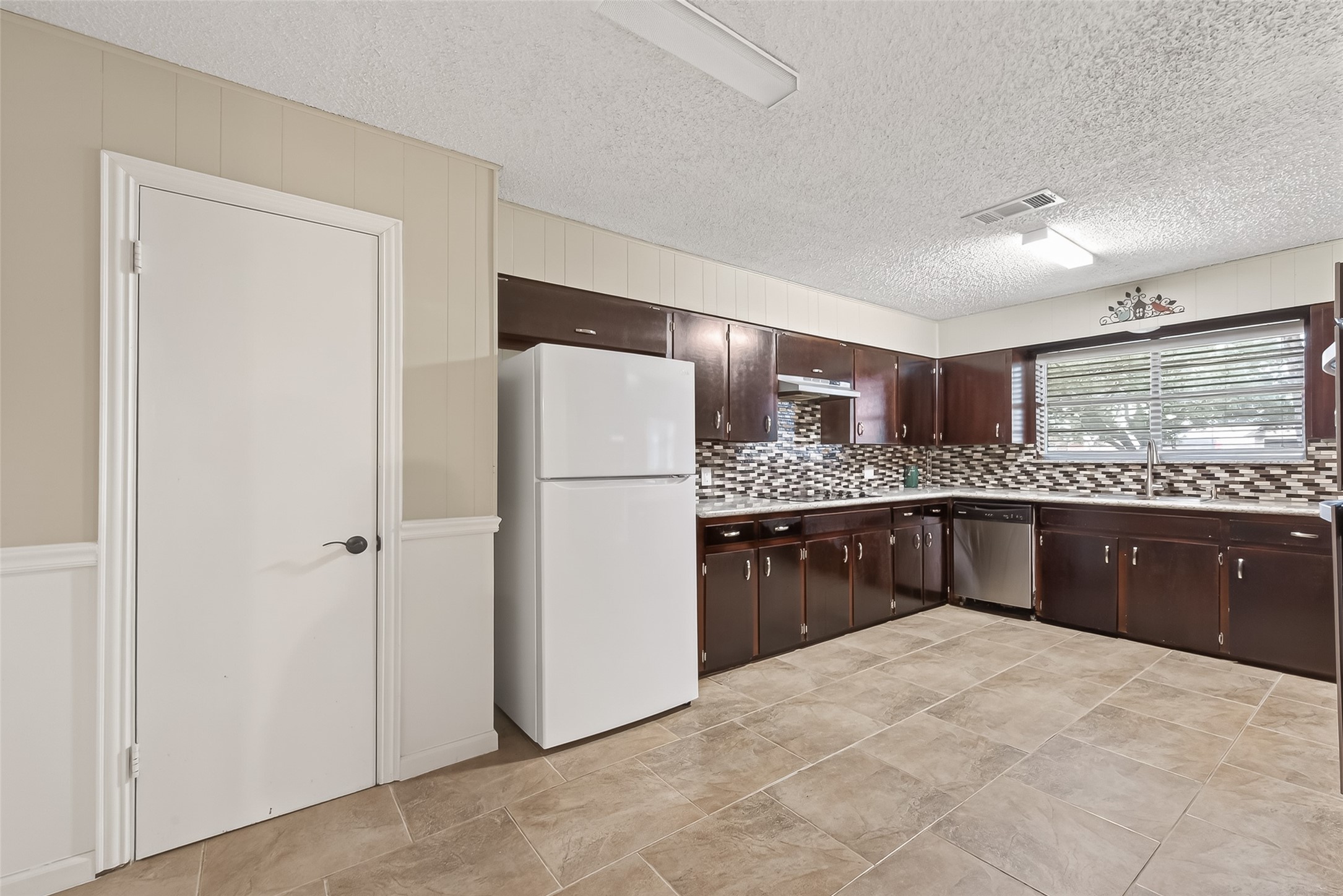 9525 Gene Street Needville, TX 77461 - Photo 14 of 48 a kitchen with a refrigerator and a sink