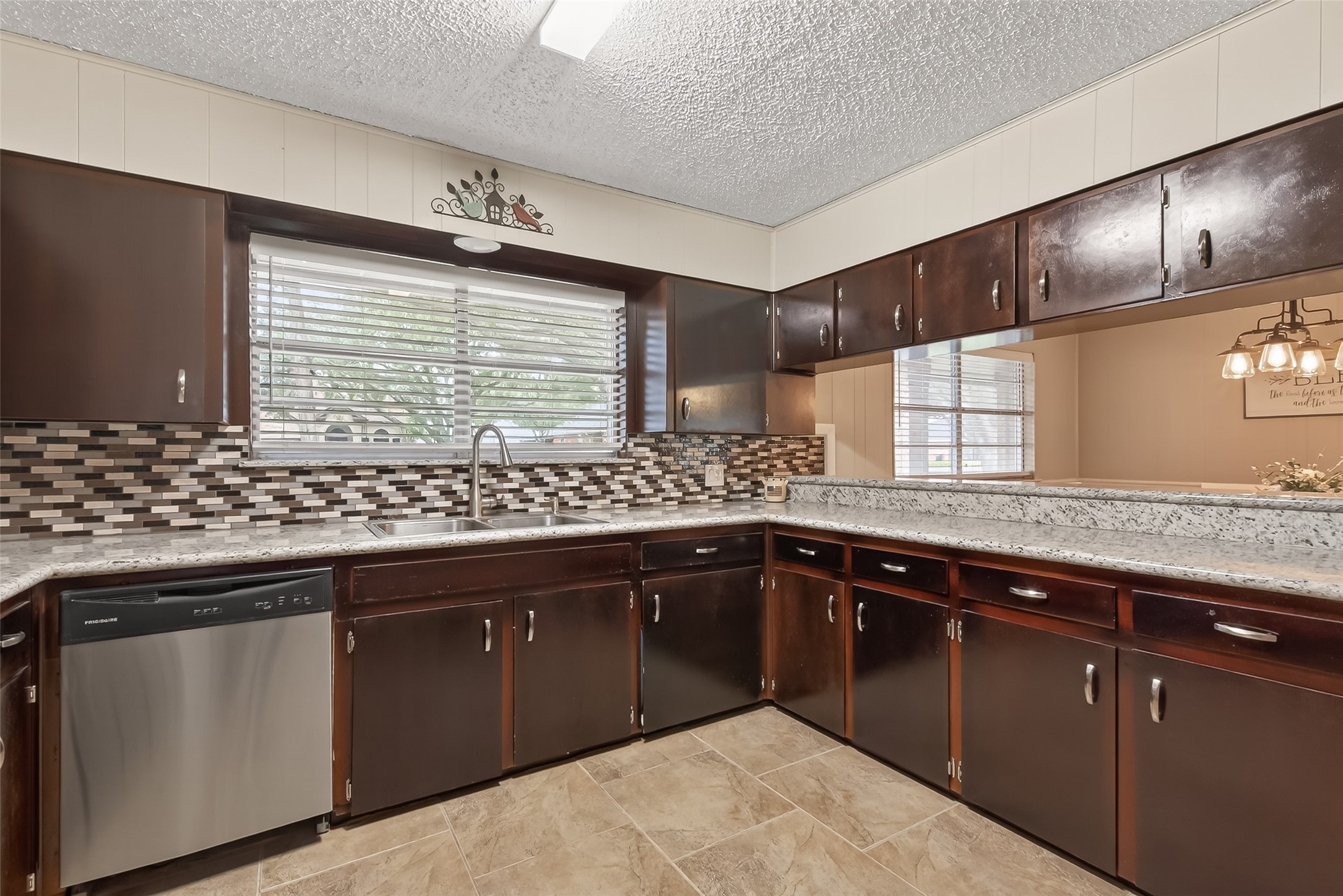 9525 Gene Street Needville, TX 77461 - Photo 18 of 48 a kitchen with granite countertop sink cabinets and stainless steel appliances