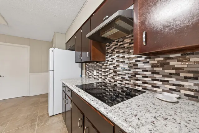 a kitchen with a stove and a refrigerator