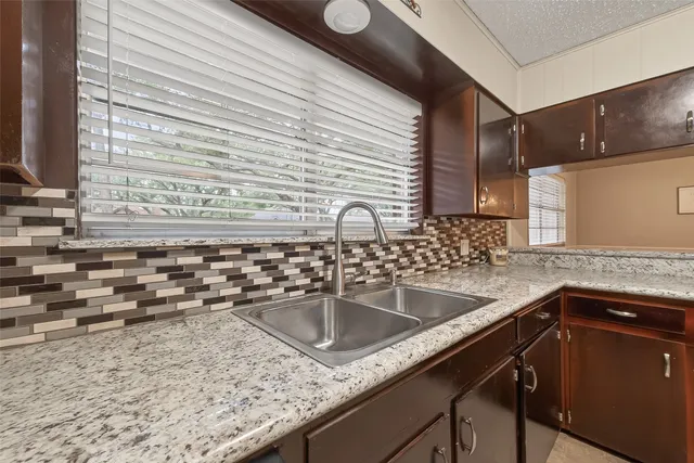 a kitchen with a sink and cabinets