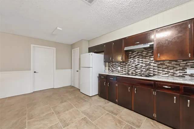 a view of kitchen with refrigerator sink and wooden floor