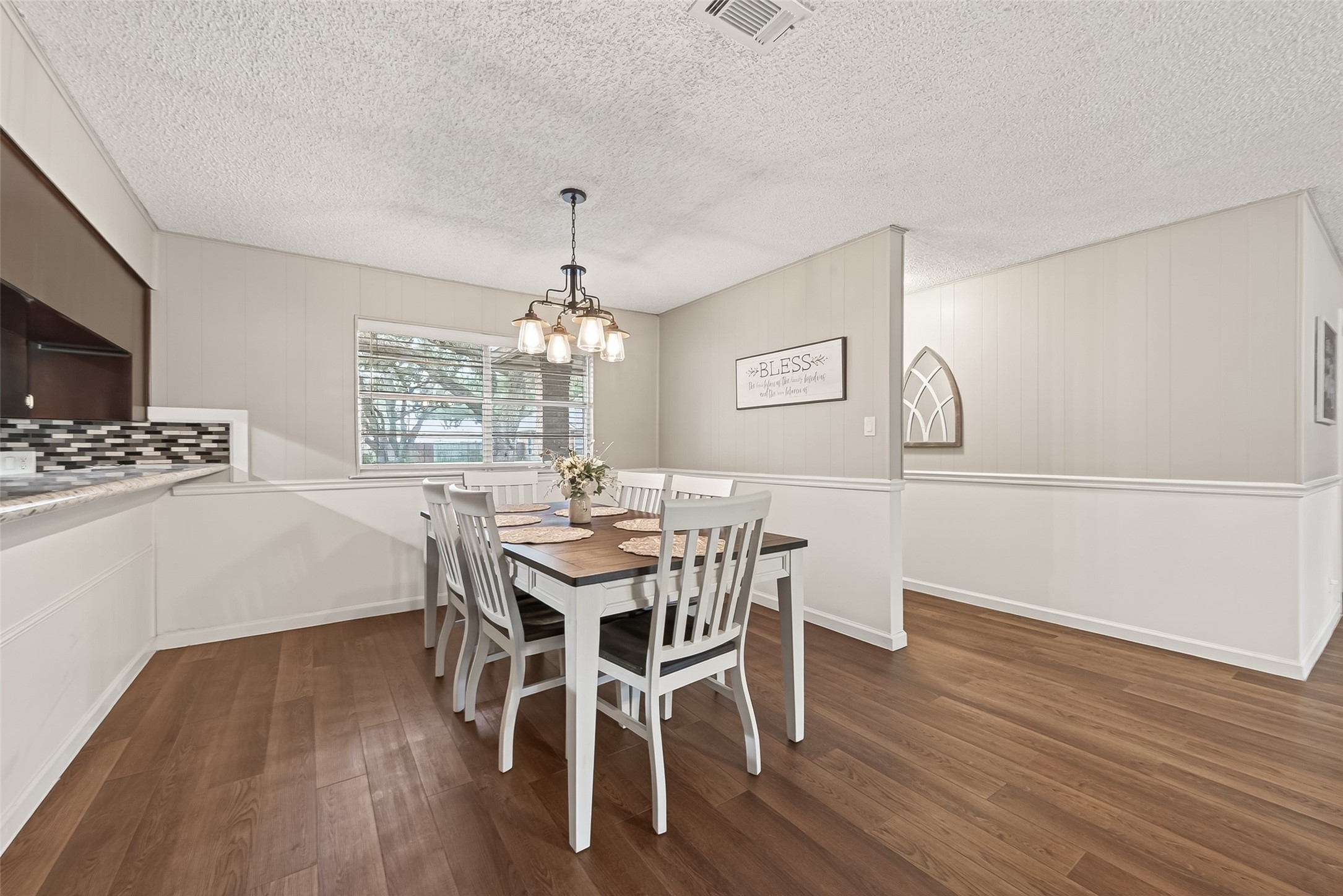 9525 Gene Street Needville, TX 77461 - Photo 24 of 48 a view of a dining room with furniture a chandelier and wooden floor