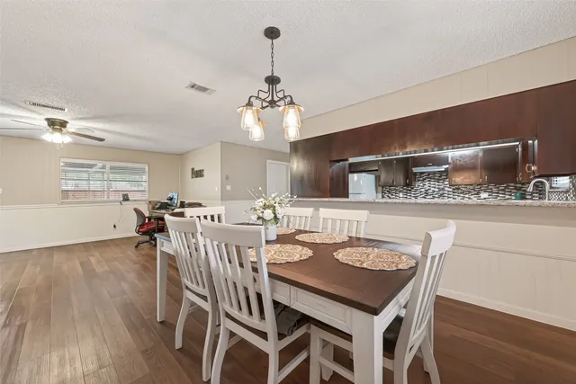 a view of a a dining room with furniture window and wooden floor