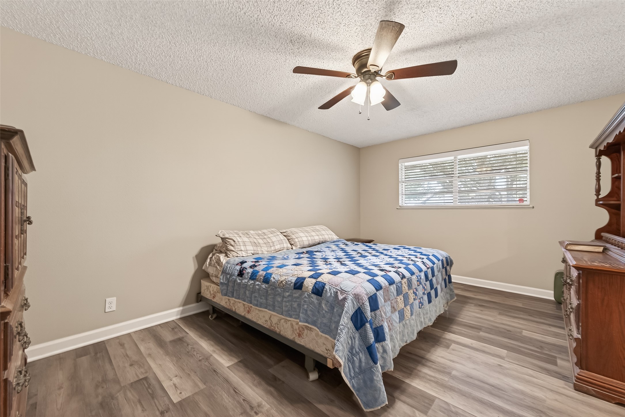 9525 Gene Street Needville, TX 77461 - Photo 27 of 48 a bedroom with a bed and wooden floor