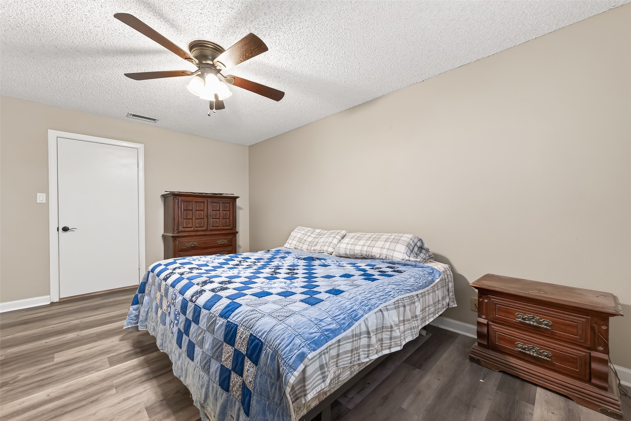 9525 Gene Street Needville, TX 77461 - Photo 28 of 48 a bedroom with a bed and a chandelier