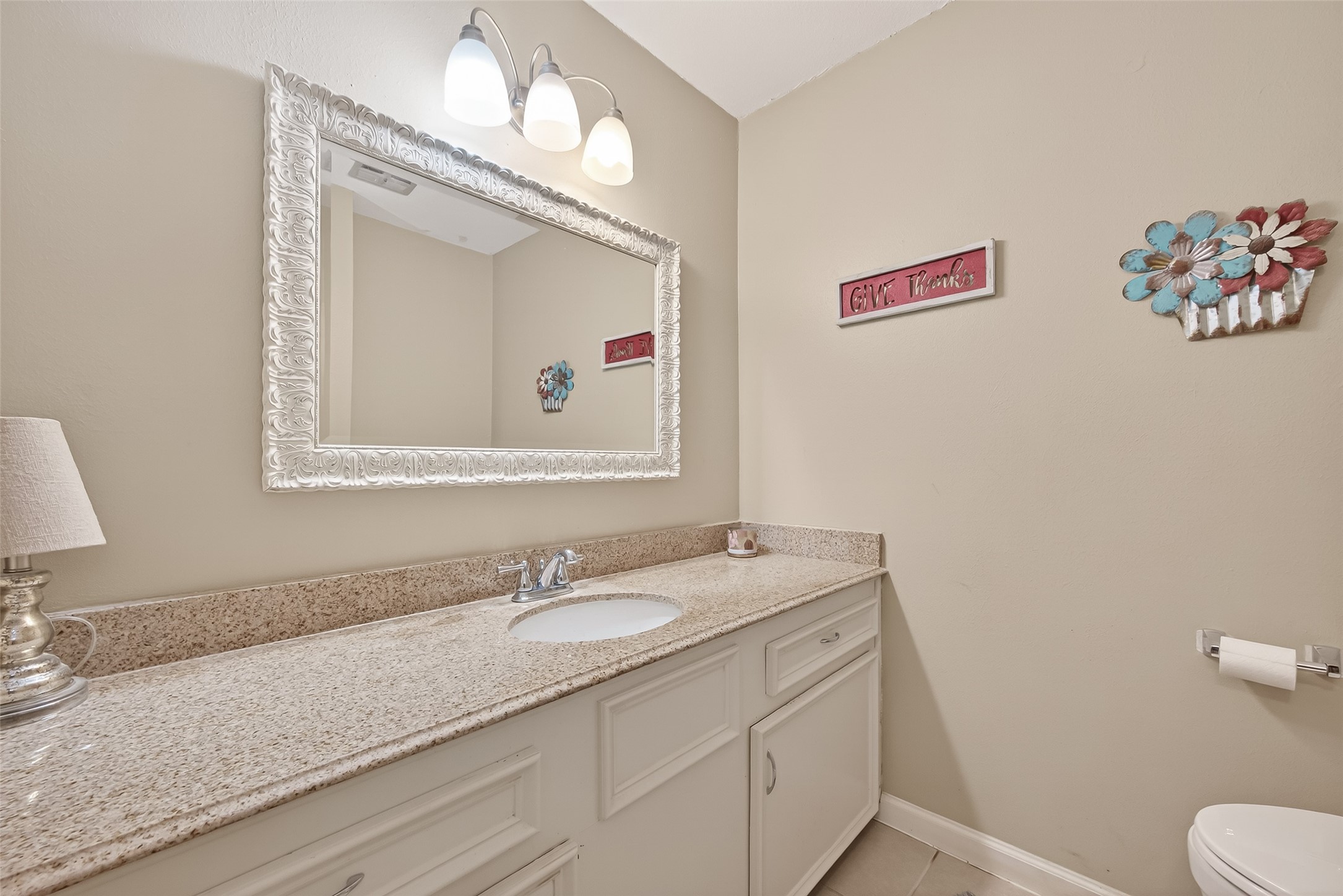 9525 Gene Street Needville, TX 77461 - Photo 30 of 48 a bathroom with a granite countertop sink mirror and vanity