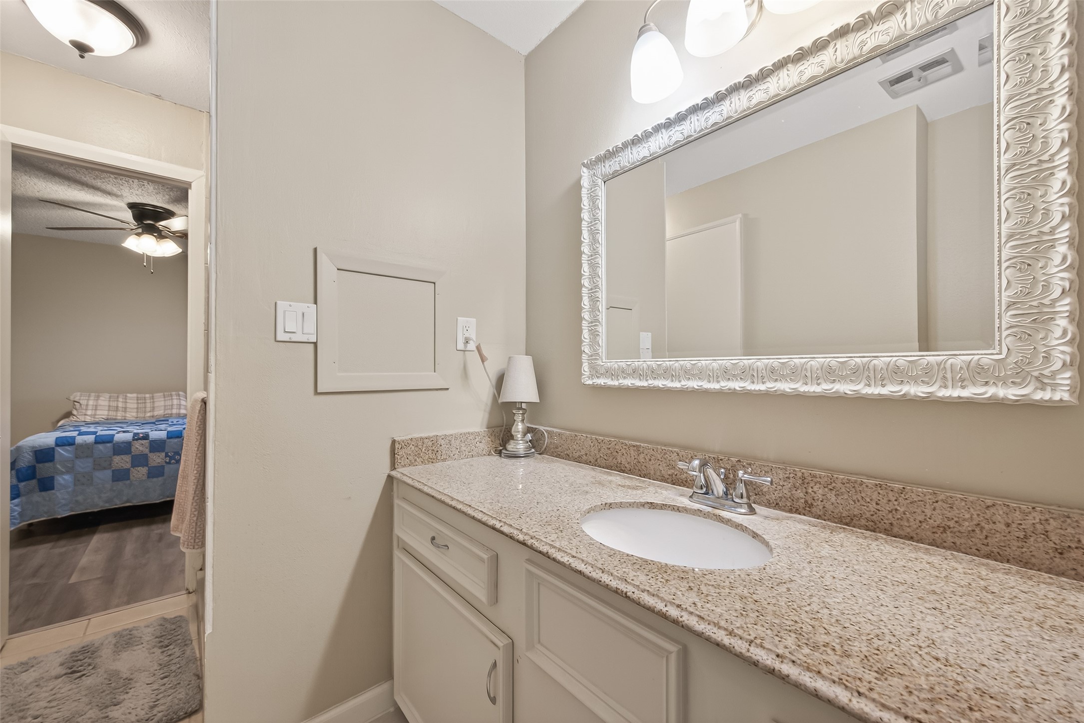 9525 Gene Street Needville, TX 77461 - Photo 31 of 48 a bathroom with a granite countertop sink and a mirror