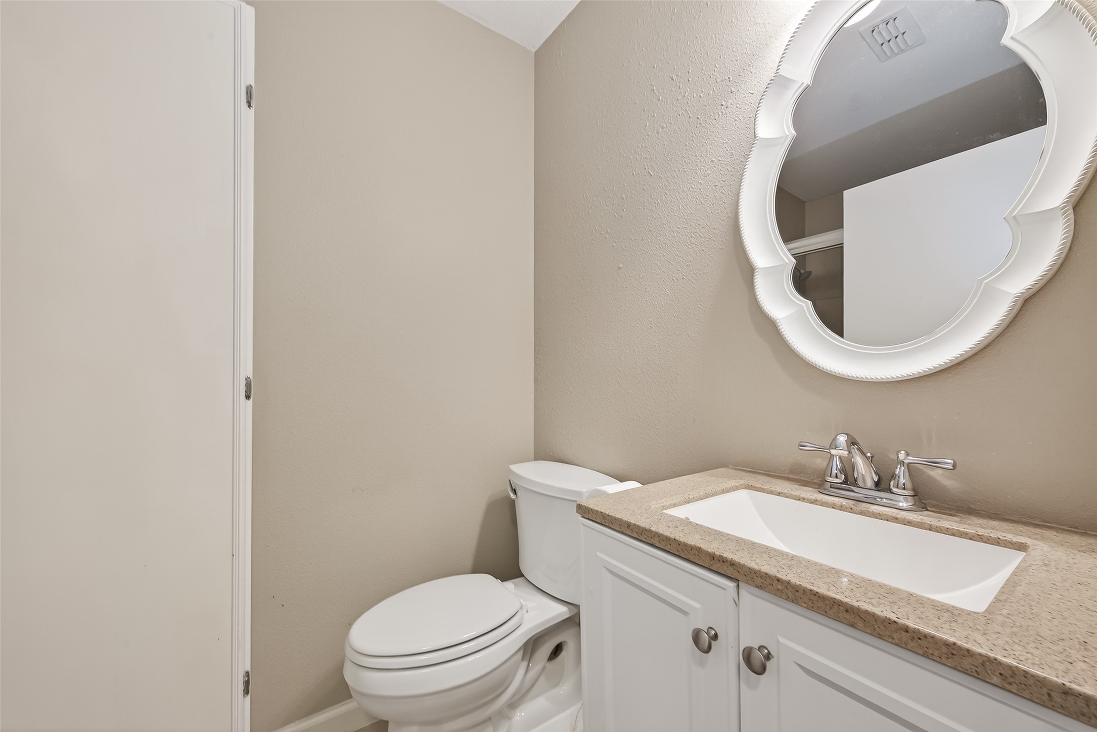9525 Gene Street Needville, TX 77461 - Photo 32 of 48 a bathroom with a granite countertop toilet sink and mirror