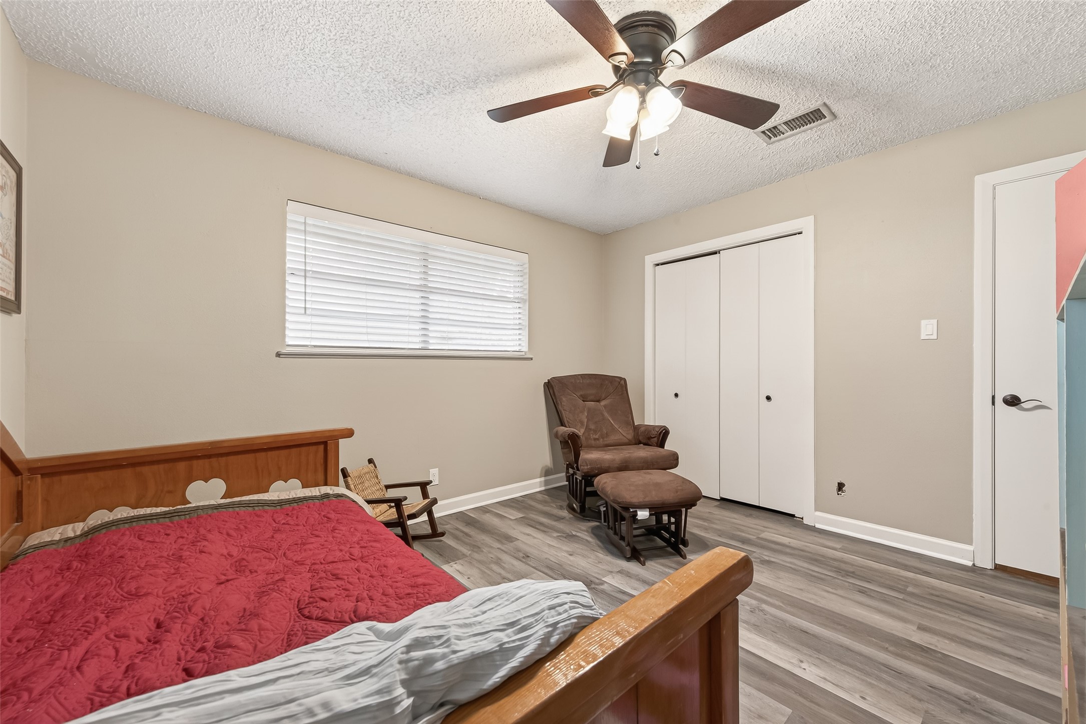 9525 Gene Street Needville, TX 77461 - Photo 35 of 48 a bedroom with a bed and a chandelier fan