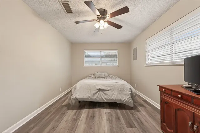 a bedroom with a bed and a flat tv screen