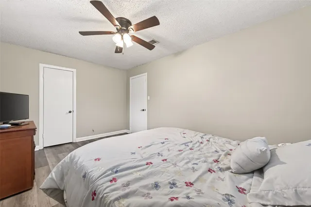 a bedroom with a large bed and a flat screen tv