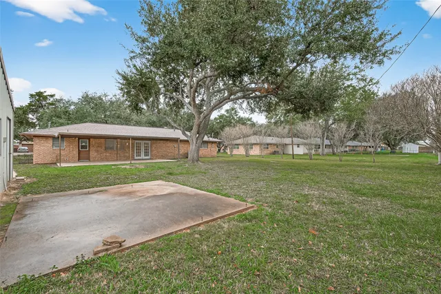 a patio with a garden and trees