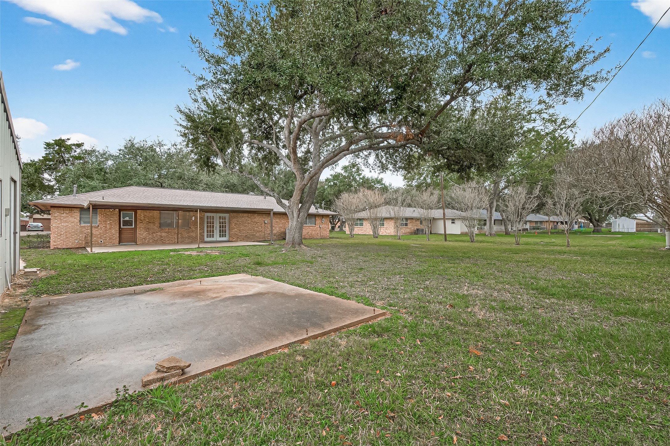 9525 Gene Street Needville, TX 77461 - Photo 42 of 48 a patio with a garden and trees