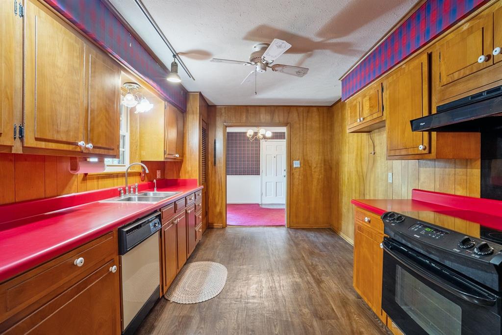 2617 Park Street Commerce, TX 75428 - Photo 12 of 34 a kitchen with stainless steel appliances kitchen island wooden cabinets and granite counter tops