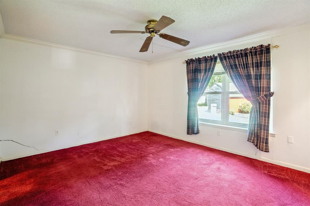 2617 Park Street Commerce, TX 75428 - Photo 15 of 34 an empty room with windows and fan