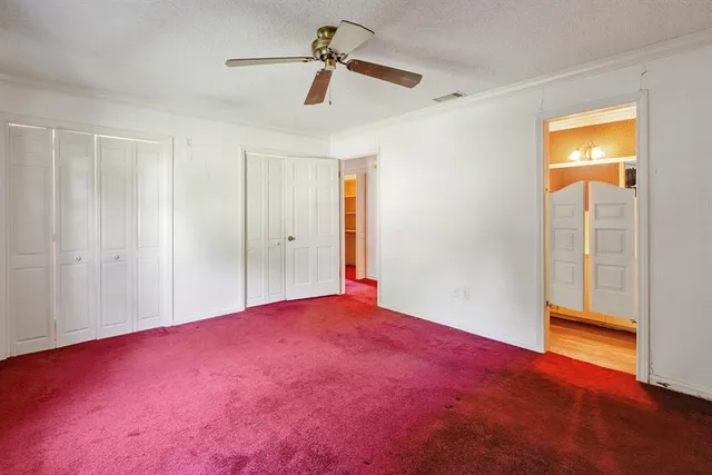 a view of empty room with ceiling fan