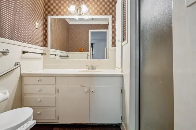 a bathroom with a sink vanity and mirror