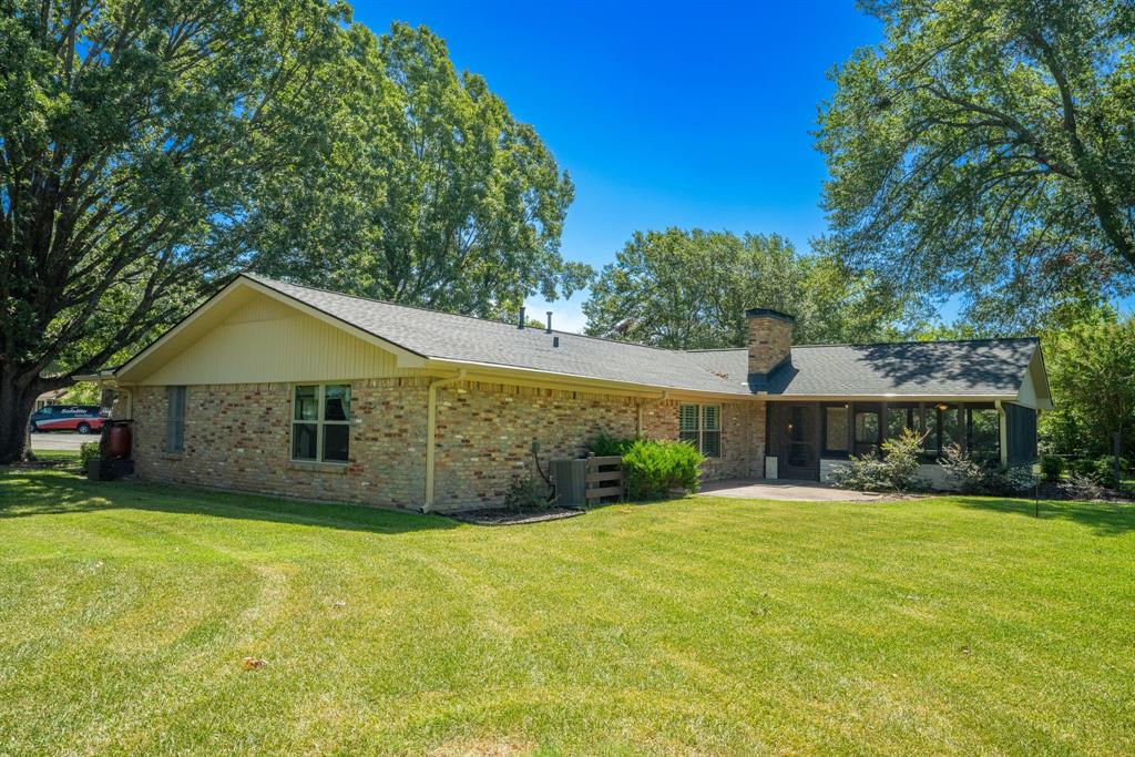 2617 Park Street Commerce, TX 75428 - Photo 27 of 34 a front view of house with yard and garage
