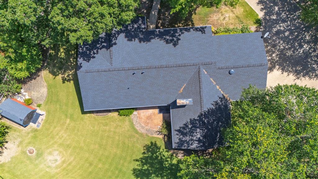 2617 Park Street Commerce, TX 75428 - Photo 31 of 34 an aerial view of residential house with outdoor space and trees all around