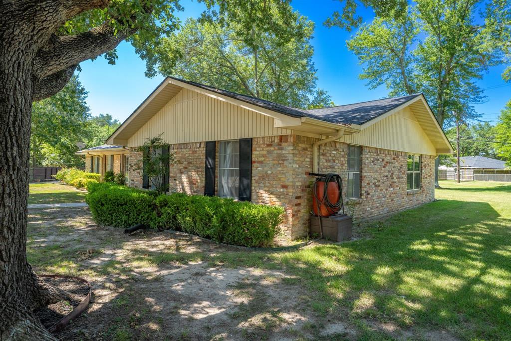 2617 Park Street Commerce, TX 75428 - Photo 33 of 34 a view of a house with a yard and tree s
