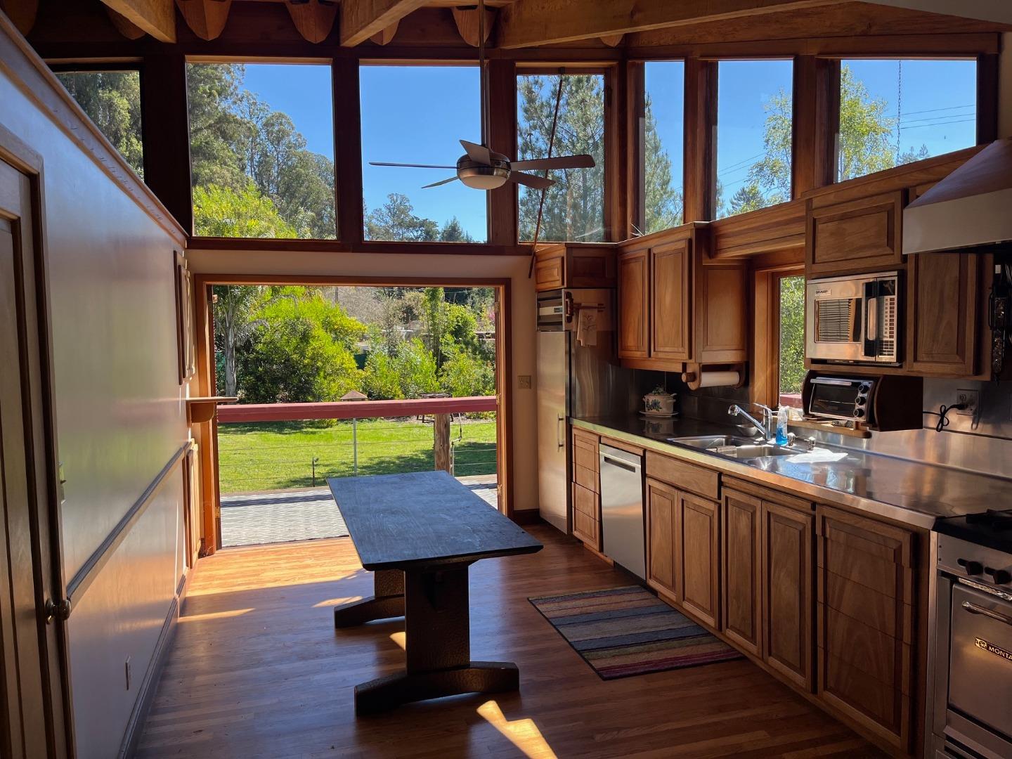 1557 Day Valley Road Aptos, CA 95003 - Photo 8 of 43 a kitchen with a wooden cabinets and outdoor view