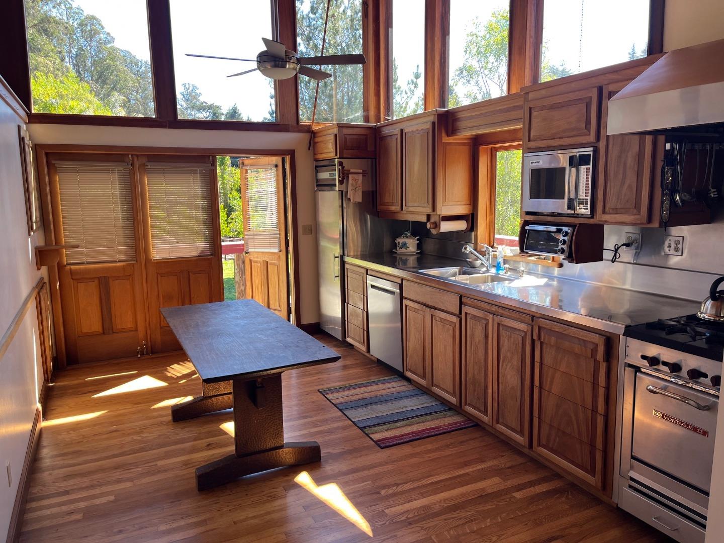 1557 Day Valley Road Aptos, CA 95003 - Photo 9 of 43 a kitchen with wooden floors a sink and a stove