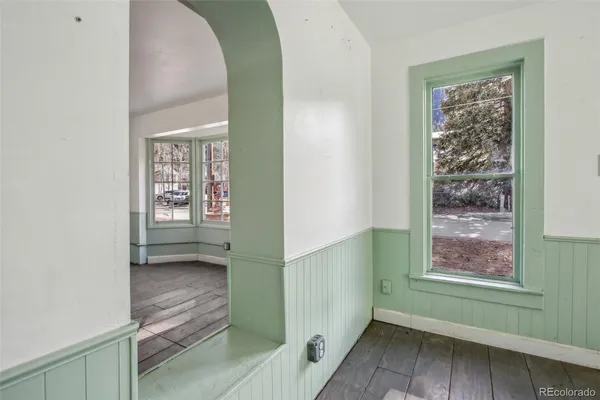 a view of a dining room with furniture and a window
