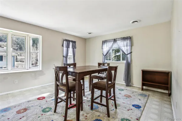 a view of a dining room with furniture and a window