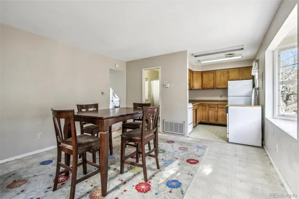 a view of a dining room with furniture and window