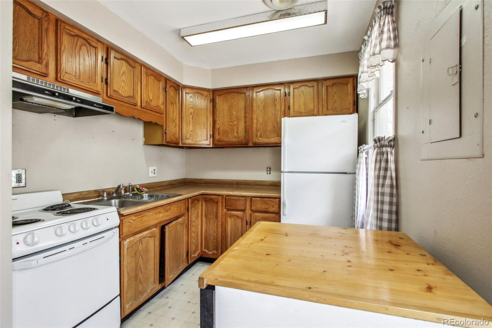 710 Sixth Street Georgetown, CO 80444 - Photo 17 of 25 a kitchen with a stove a refrigerator and a sink