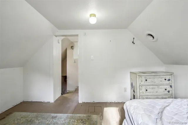 a living room with a large window and furniture