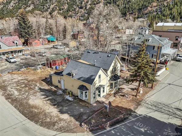 an aerial view of a house with a yard