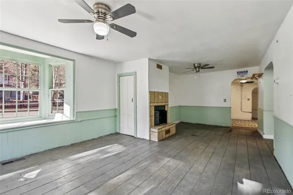 wooden floor in an empty room with a window