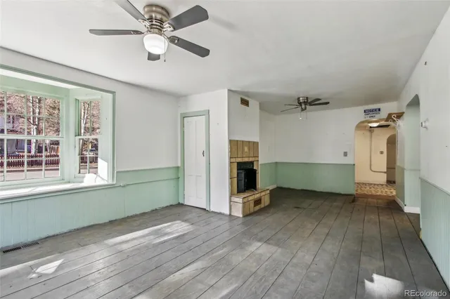 wooden floor in an empty room with a window