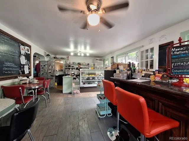 a living room with lots of furniture and kitchen view