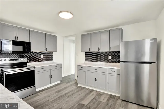 a kitchen with a refrigerator stove and sink