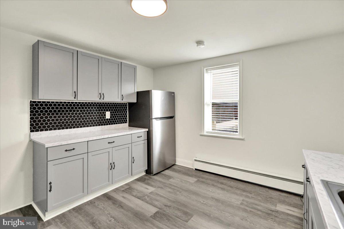 32 South Front Street St. Clair, PA 17970 - Photo 12 of 30 a kitchen with a refrigerator and white cabinets