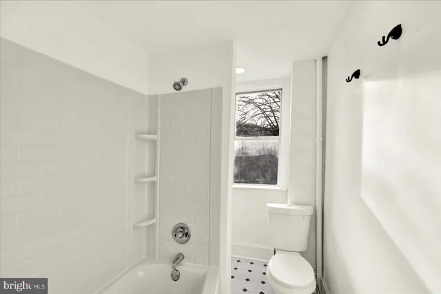 a bathroom with a shower toilet and sink