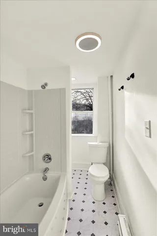 a bathroom with a bathtub sink and toilet