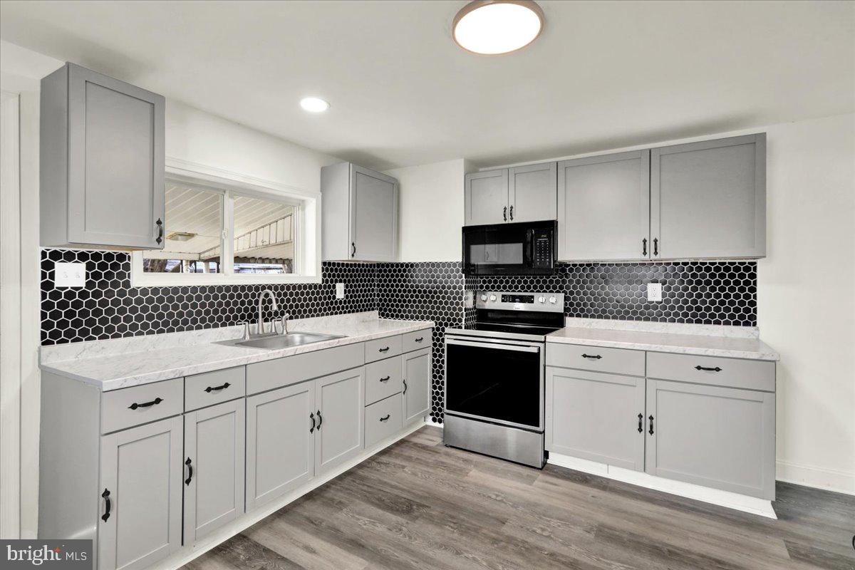 32 South Front Street St. Clair, PA 17970 - Photo 10 of 30 a kitchen with granite countertop a sink cabinets and stainless steel appliances