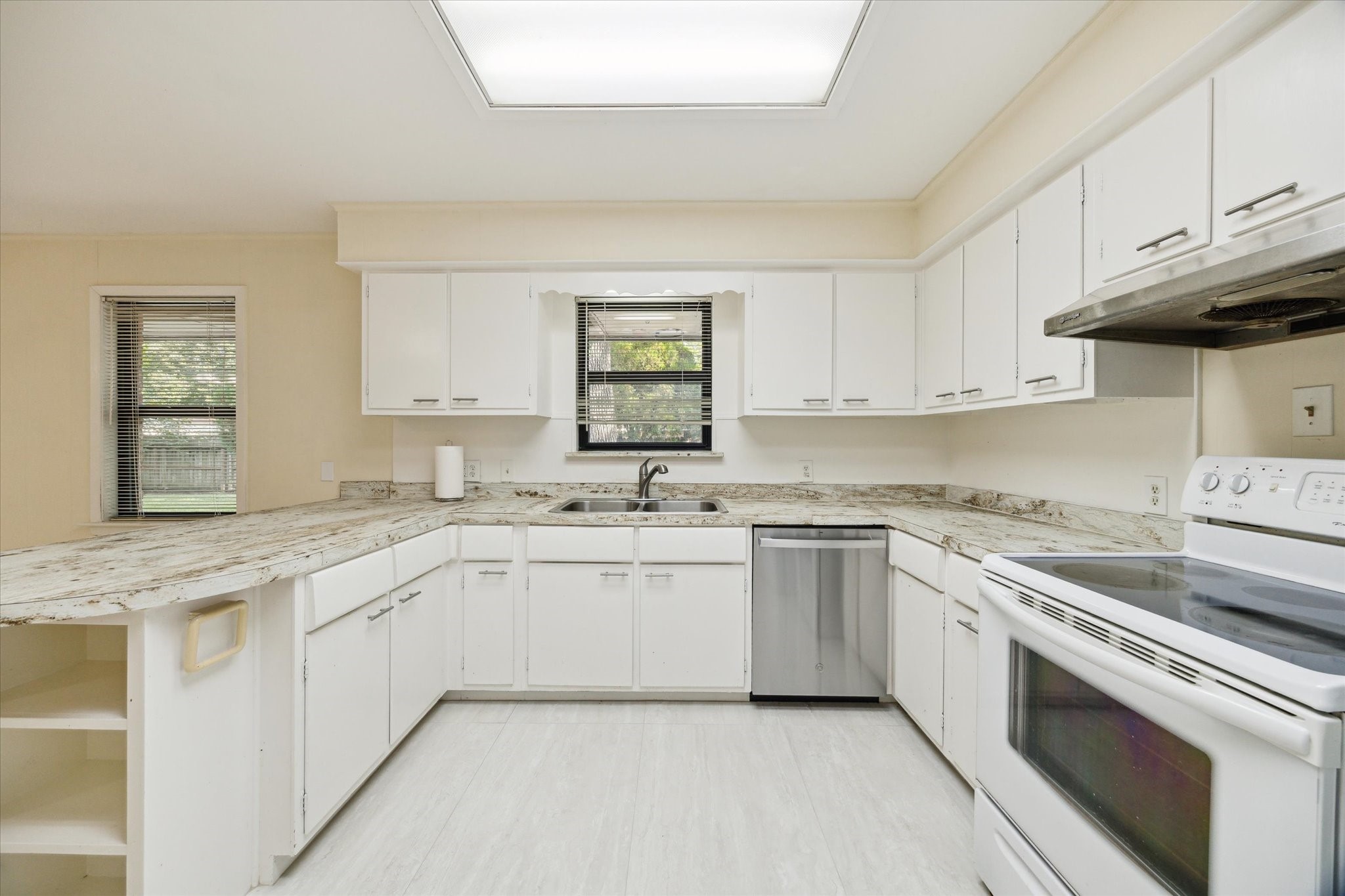 8907 Autauga Street Houston, TX 77080 - Photo 9 of 20 This kitchen space is bright with a large window above the sink and ample lighting. The layout is both functional and inviting.