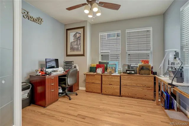 a view of a workspace with wooden floor and closet